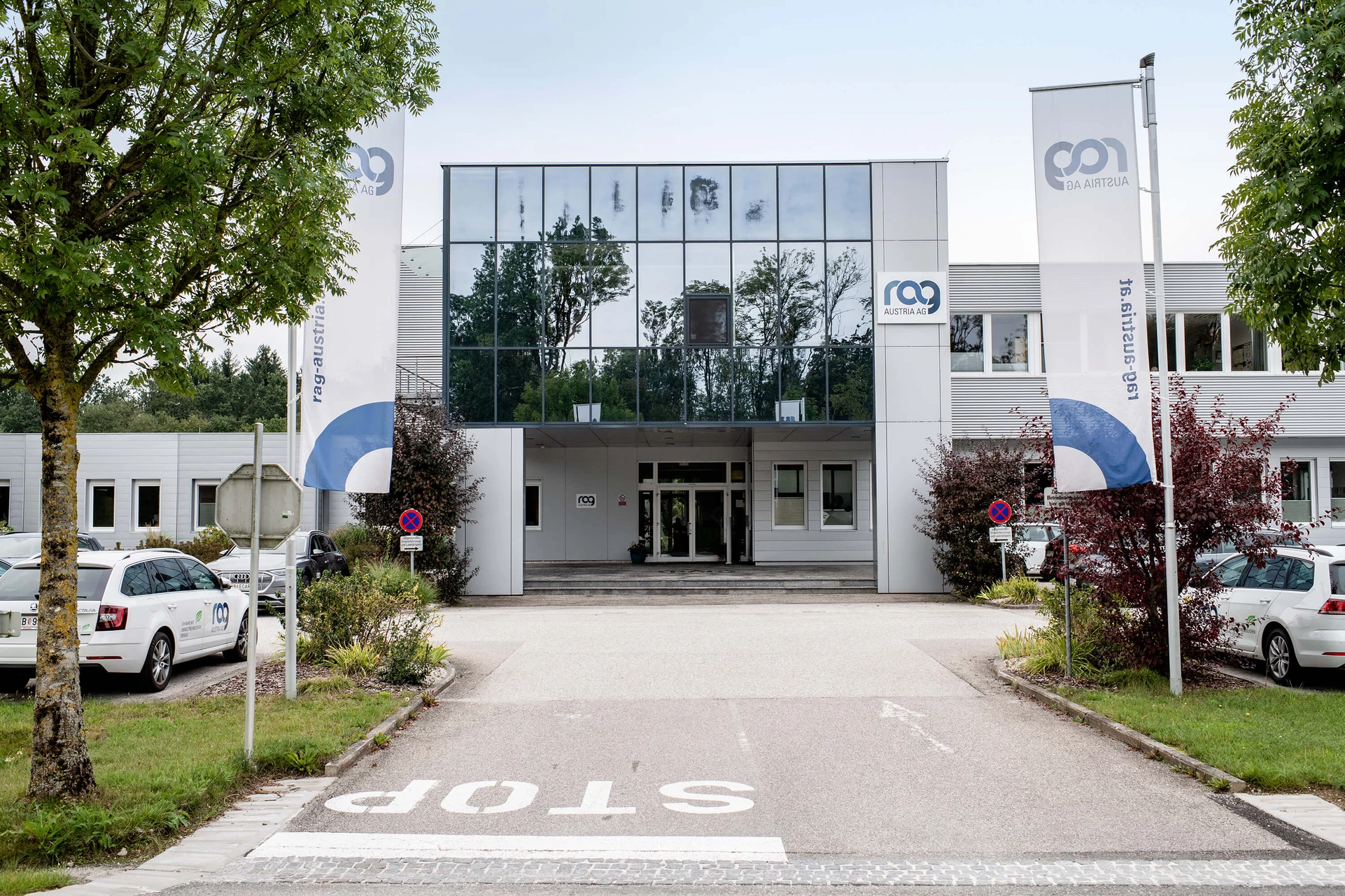 Gampern office building with asphalt and trees